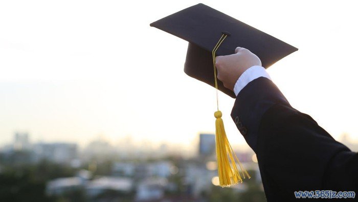 A picture of a man holding a graduation hat